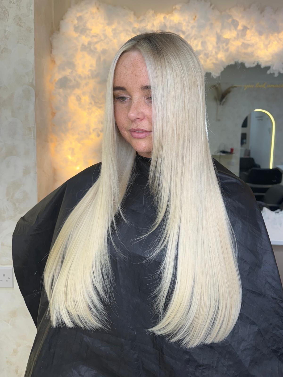Bright platinum blonde hair, sleek and glossy